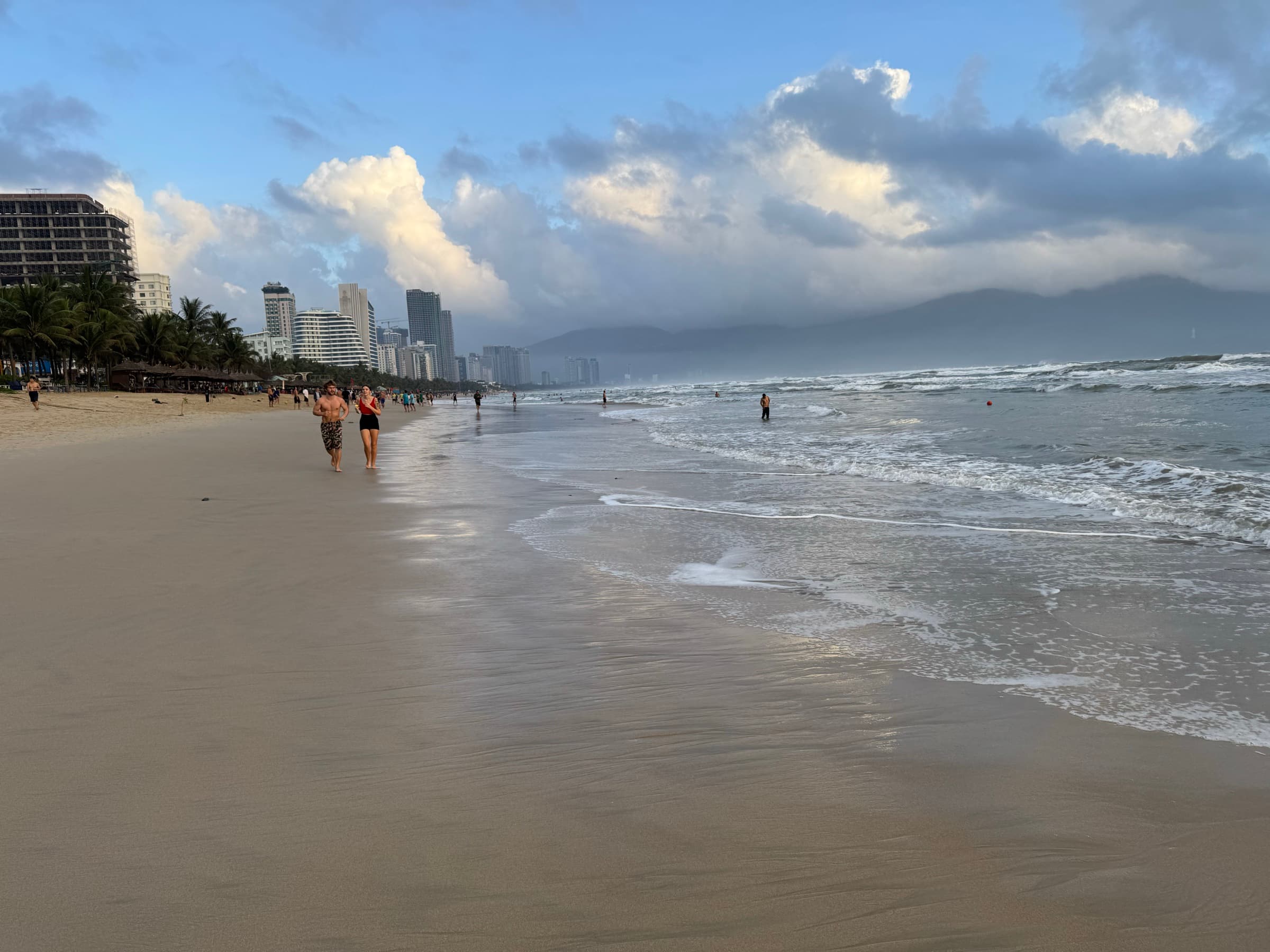 My Khe Beach in Da Nang at dusk, with the city skyline in the distance